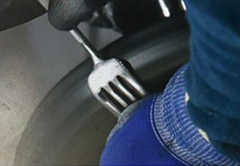 Close-up of stainless steel fork during the polishing process